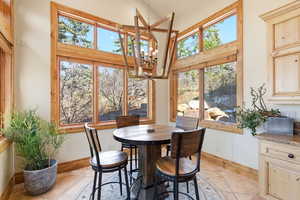 Dining room with hanging lights and light tile patterned flooring