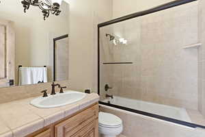 Bathroom with vanity and tiled shower / bath