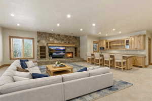 Living room with light carpet, a fireplace, and recessed lighting