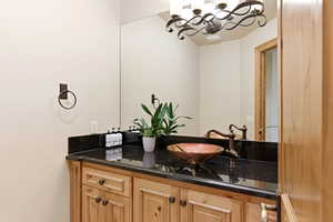 Bathroom with vanity and suspended lighting