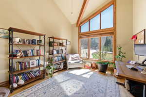 Office space with vaulted ceiling and light wood finished floors