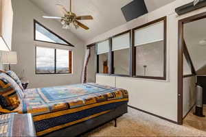 Bedroom featuring light carpet, vaulted ceiling, and ceiling fan