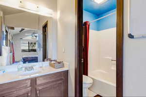 Bathroom with vanity, ensuite bathroom, and shower / tub combo with curtain