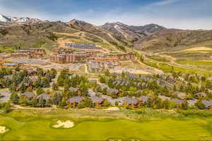 Drone / aerial view of a mountainous background and a golf course