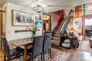 Dining area featuring hardwood / wood-style floors and a textured ceiling