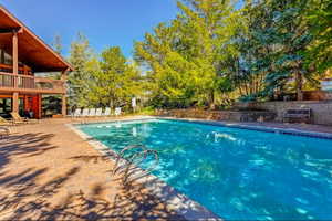 Community pool with a patio
