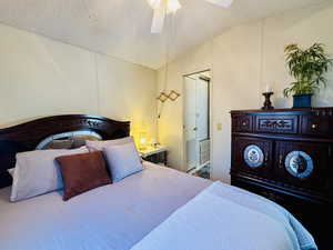 Bedroom featuring a textured ceiling and ceiling fan