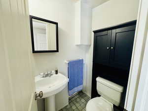 Half bathroom featuring a textured ceiling and tile patterned floors