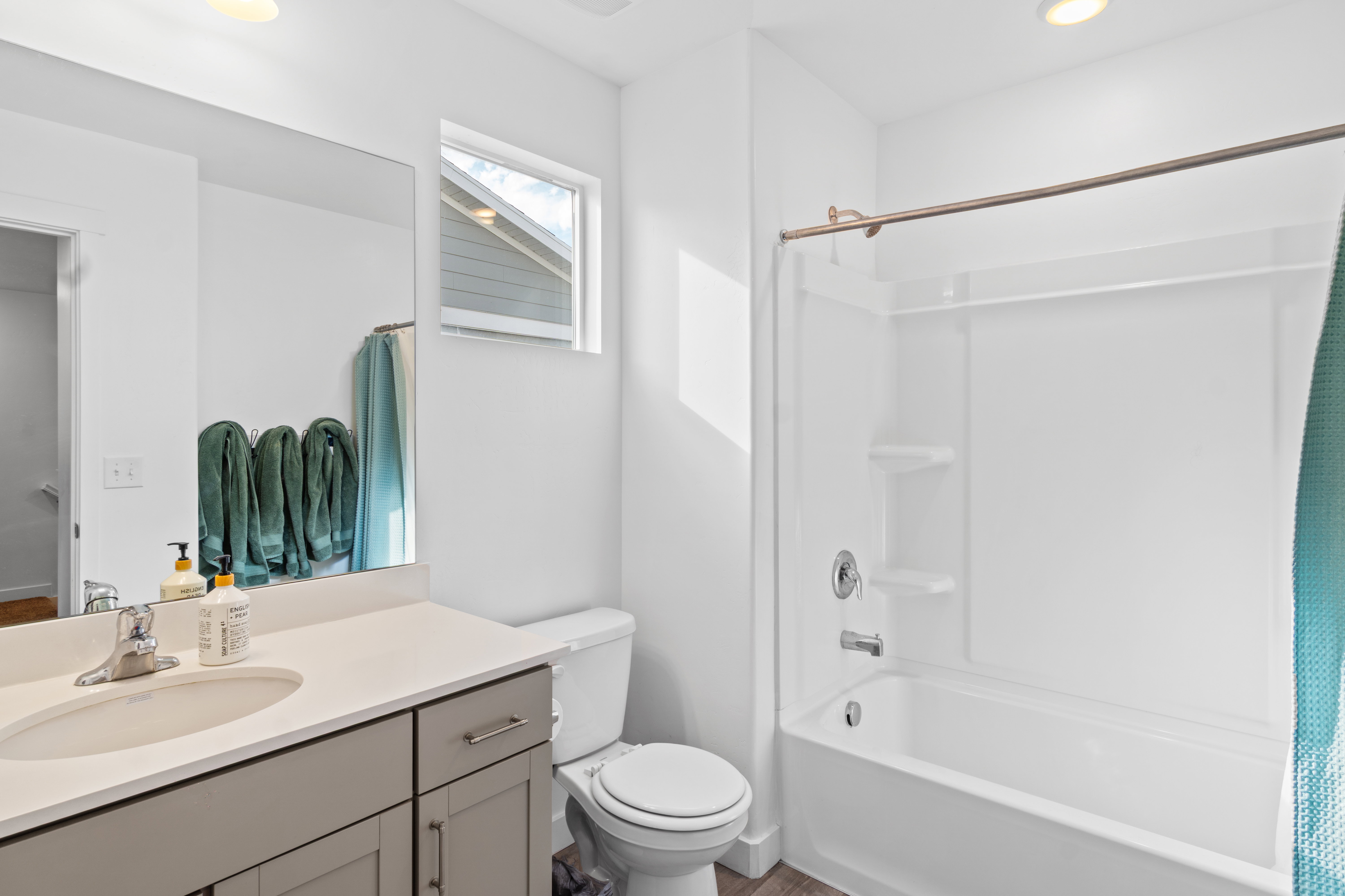 Bathroom featuring vanity, shower / tub combo