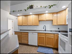 Kitchen featuring white appliances, recessed lighting, and light countertops