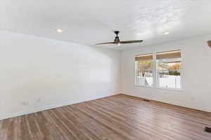 Spare room with light wood-style flooring, a textured ceiling, recessed lighting, and a ceiling fan