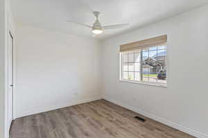 Unfurnished room featuring light wood-style flooring and a ceiling fan