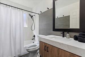 Full bath featuring vanity, shower / bath combo with shower curtain, tile walls, and decorative backsplash