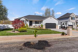 Ranch-style house featuring covered porch, driveway, a garage, a shingled roof, and stucco siding