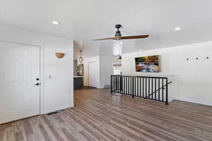 Spare room featuring light wood-style floors, ceiling fan, and recessed lighting
