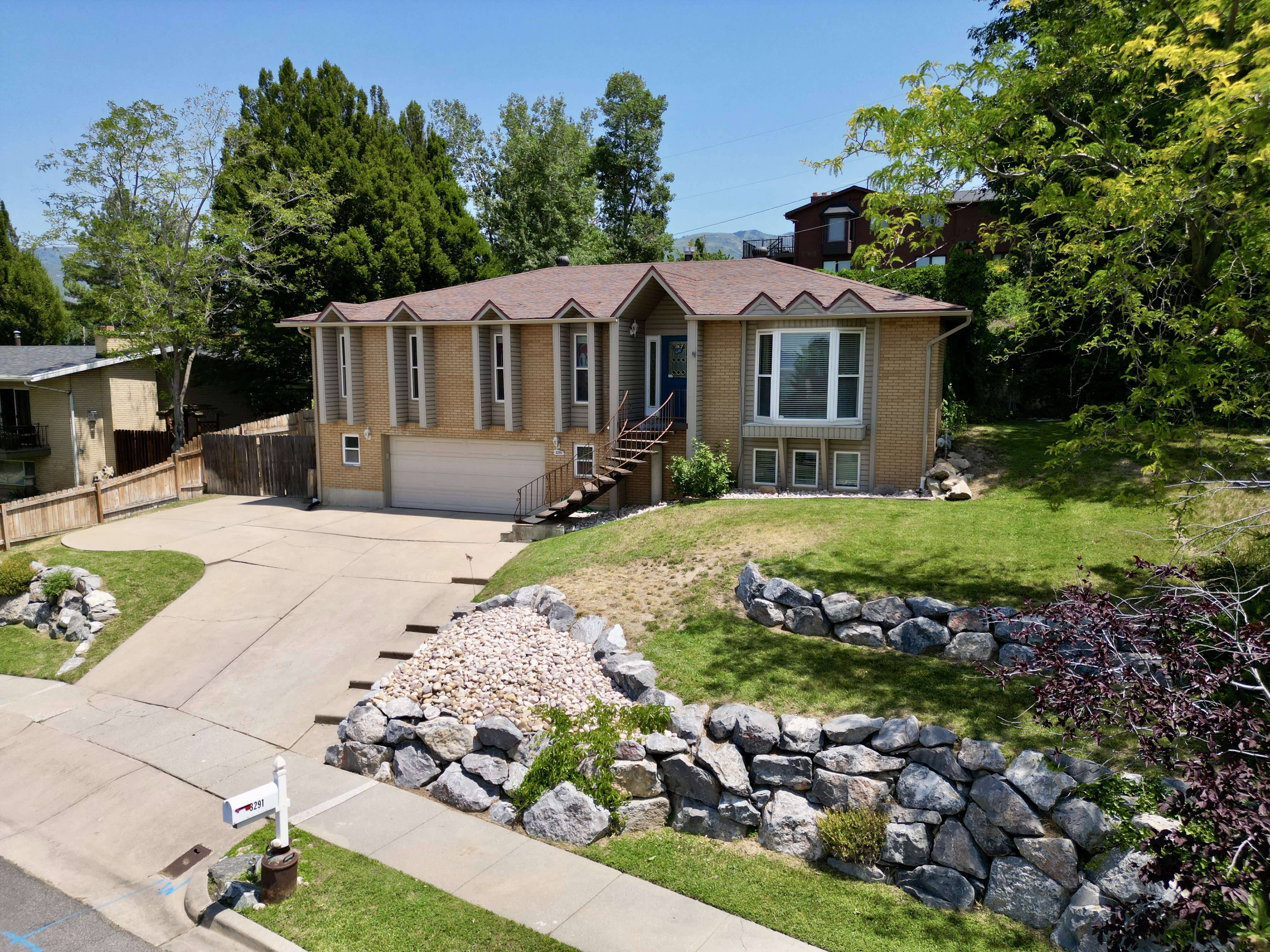 Single story home with concrete driveway, brick siding, and a garage