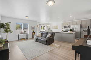 Living room with plenty of natural lighting, light wood-type flooring, and open floor plan