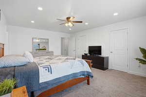 Carpeted bedroom featuring recessed lighting and a ceiling fan