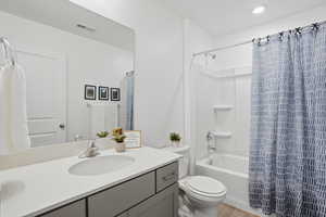 Full bath featuring vanity, shower / bathtub combination with curtain