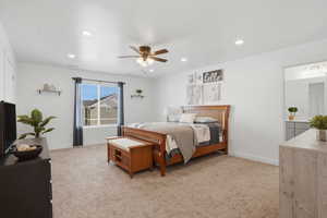 Bedroom featuring light colored carpet, ceiling fan, and recessed lighting