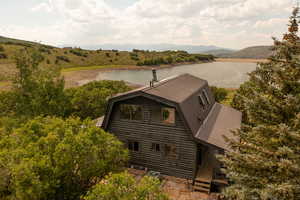 View of subject property with a water and mountain view