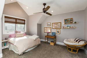Carpeted bedroom featuring vaulted ceiling, a ceiling fan, and recessed lighting