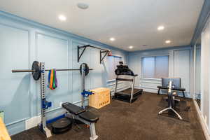 Workout area featuring a decorative wall, recessed lighting, a baseboard heating unit, and a textured ceiling