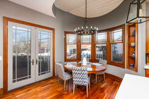 Dining space featuring hardwood / wood-style flooring and suspended lighting