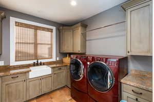 Laundry room featuring separate washer and dryer, cabinet space, light tile patterned floors, and recessed lighting
