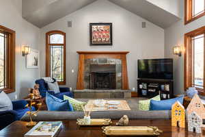 Living room featuring a high ceiling and a premium fireplace
