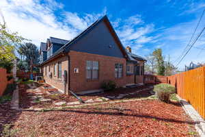 View of home's exterior with a fenced backyard and brick siding