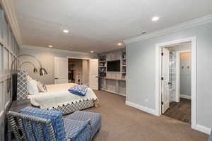 Carpeted bedroom with ornamental molding, recessed lighting, and connected bathroom