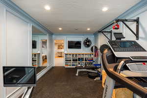 Exercise area with recessed lighting and a textured ceiling