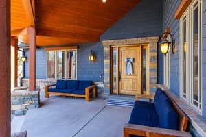 Doorway to property featuring outdoor seating and covered porch