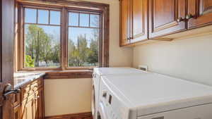 Laundry room featuring cabinet space and washer and dryer
