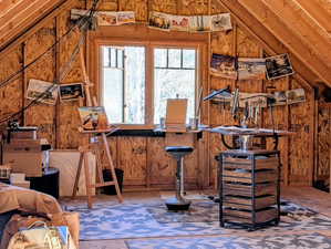 Bar area featuring lofted ceiling and wooden walls