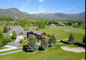Drone / aerial view of a golf club and a mountain backdrop