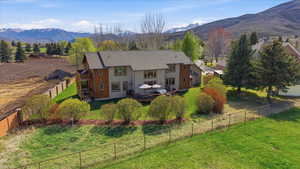 Rear view of property featuring a fenced backyard and a deck with mountain view