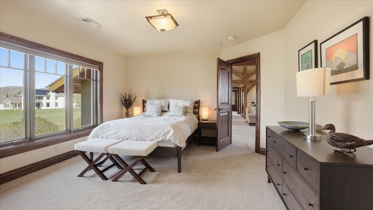 Bedroom featuring light colored carpet and baseboards