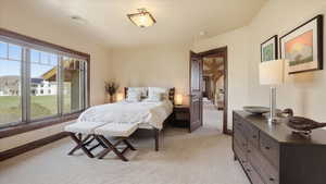 Bedroom featuring light colored carpet and baseboards