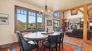 Dining area featuring a fireplace, hardwood / wood-style floors, suspended lighting, and built in features