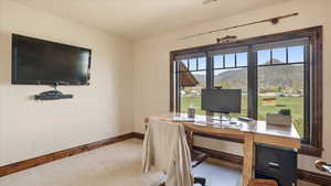 Carpeted office with baseboards
