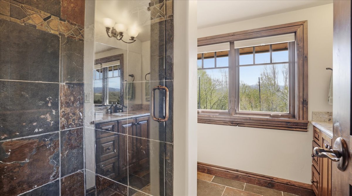 Full bathroom with vanity and a stall shower