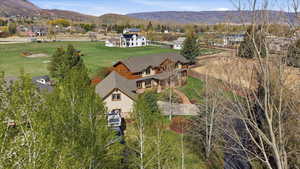 Aerial view of property and surrounding area with mountains