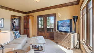 Living room with light carpet and crown molding