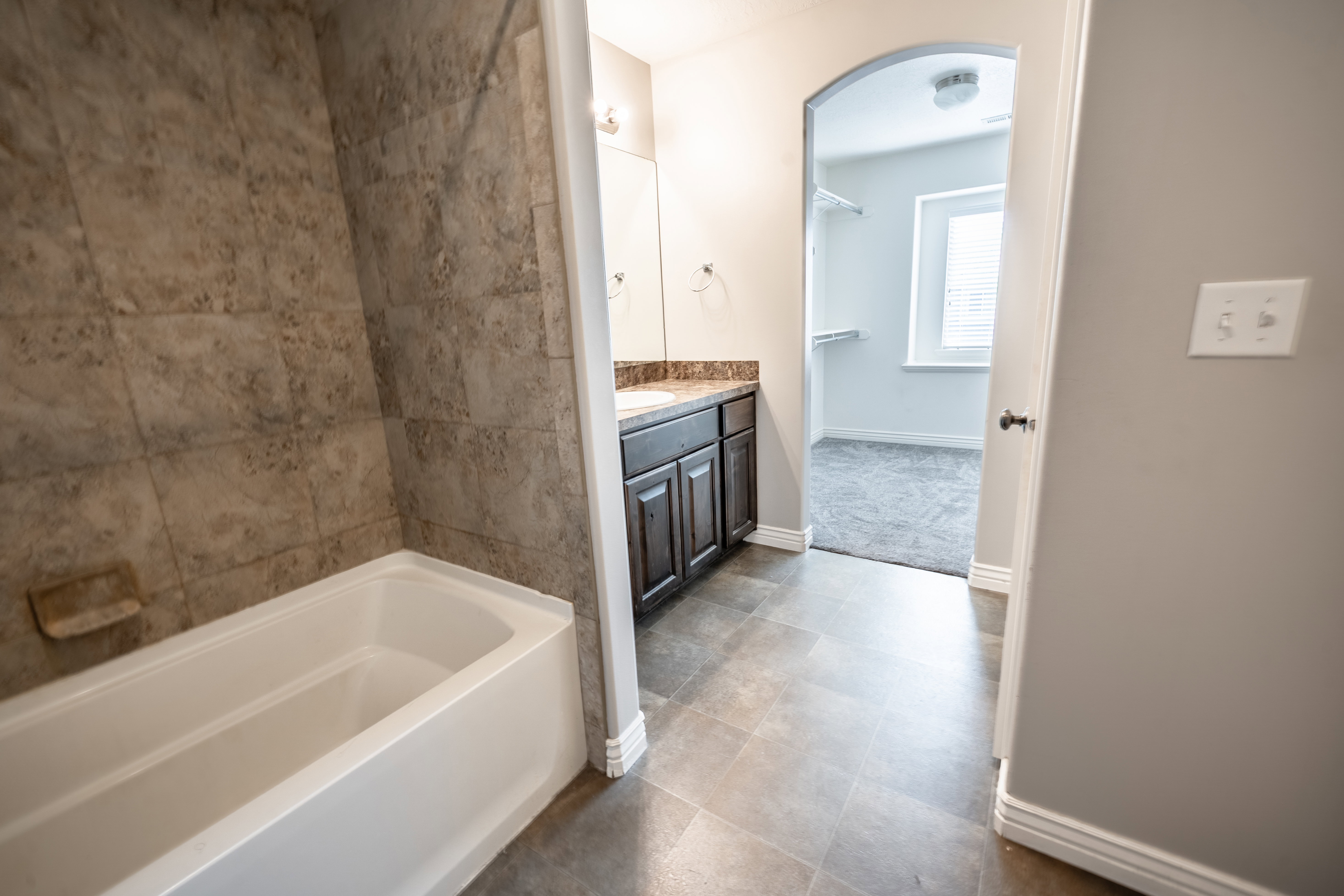 Full bath with a bathtub and vanity