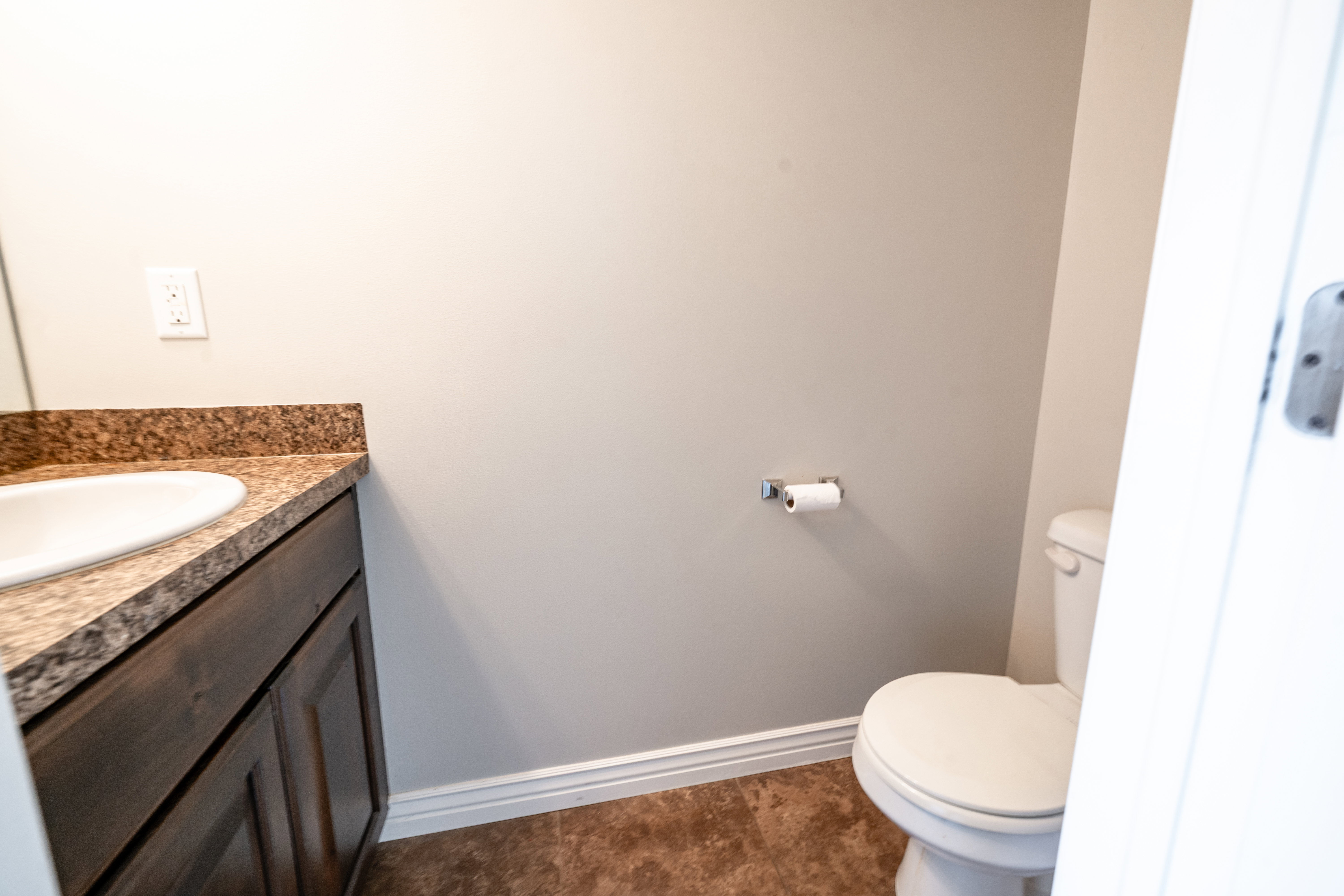 Bathroom featuring vanity and dark tile patterned flooring