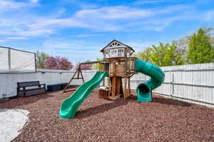 View of play area featuring a fenced backyard