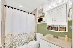 Bathroom with vanity and curtained shower