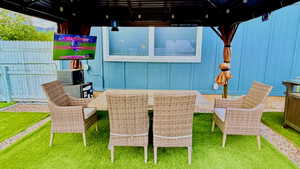 Outdoor covered patio featuring a mounted screen, recessed lighting, and a durable metal frame